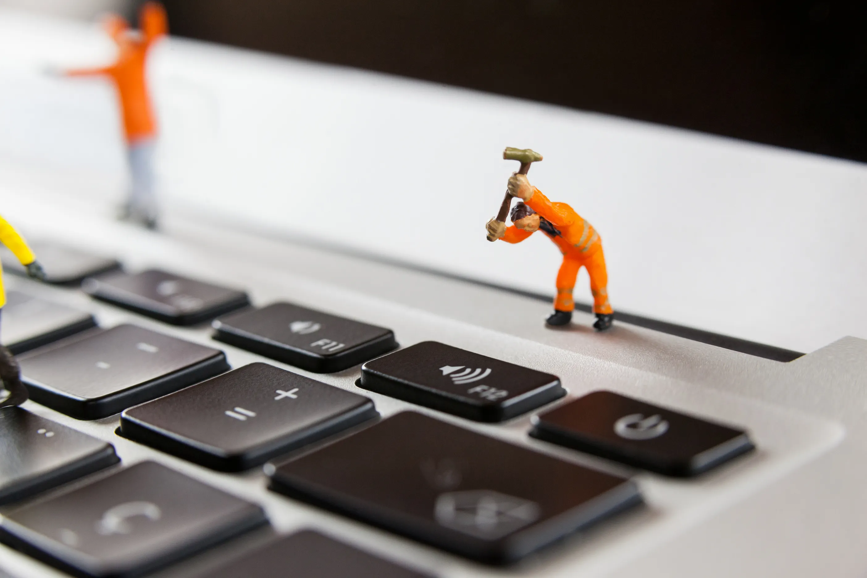 Miniature repair worker fixing a computer keyboard